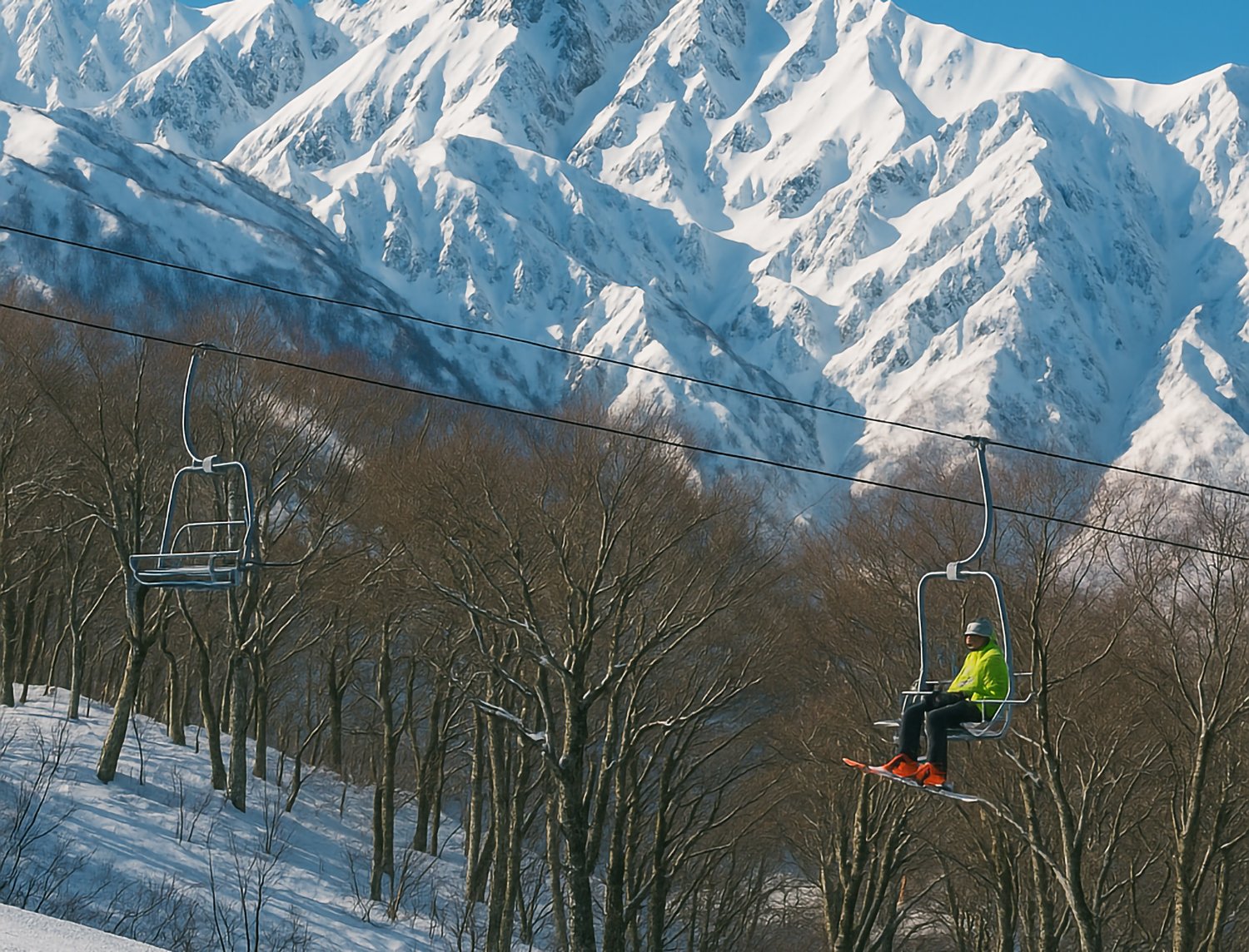 Ski lift running through snowy mountains in Hakuba