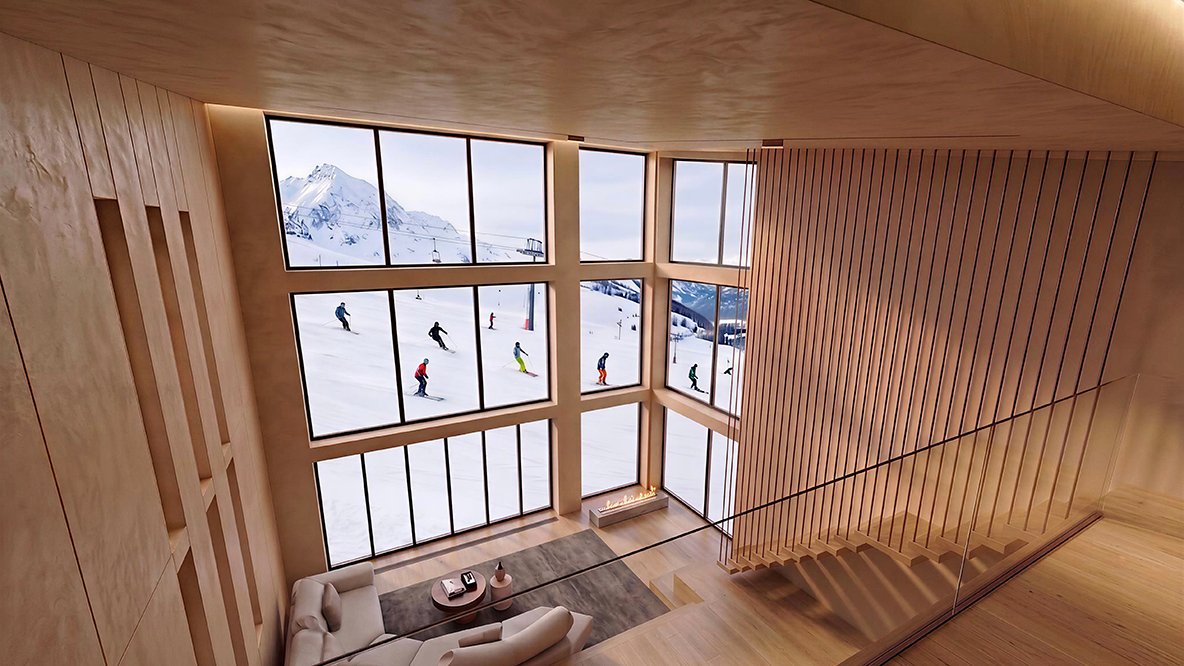中二階から見た天井までの窓越しに広がるゲレンデとスキーヤー、雪化粧の山並み